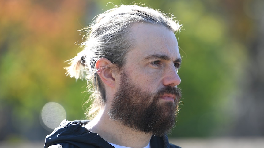 Co-CEO of Atlassian Mike Cannon-Brookes attends a press conference looking to the side 