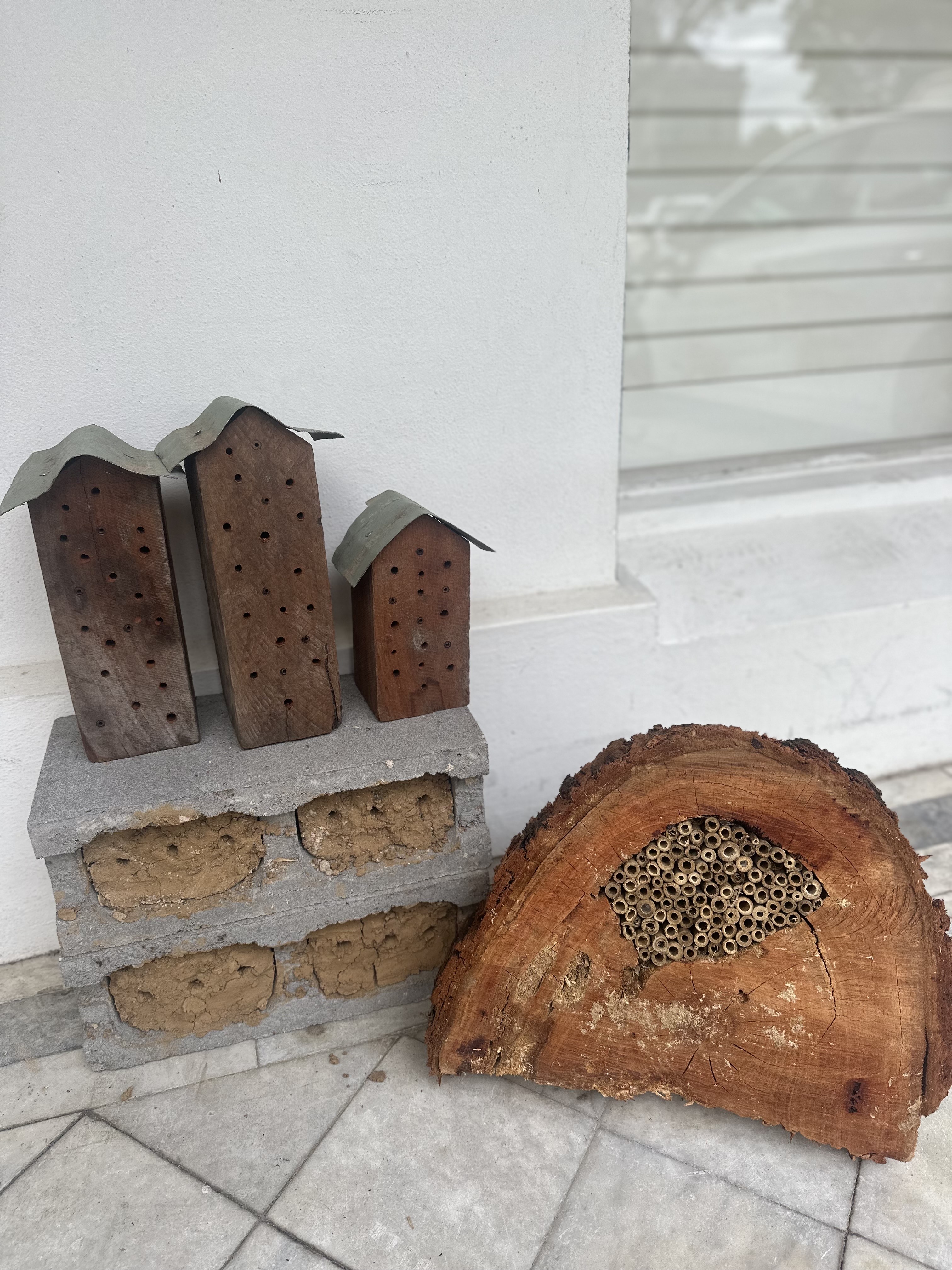A photo of bee hotels made out of different organic materials.