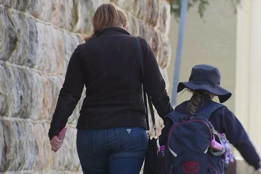 Woman and schoolgirl walking