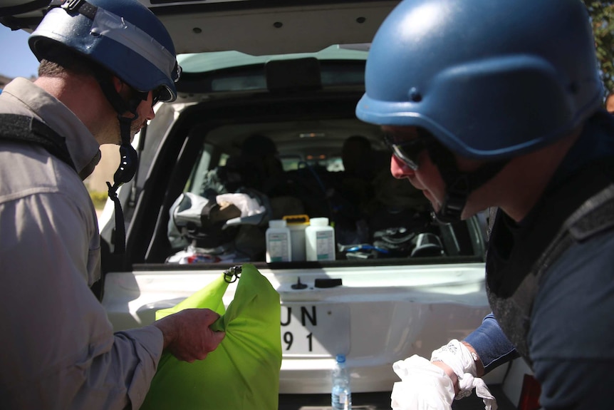 Chemical weapons experts put samples in their car