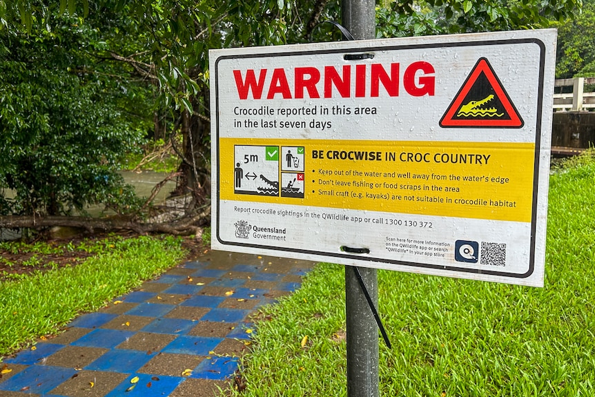 warning sign about recent crocodile sighting at Cairns creek which is a popular swimming hole