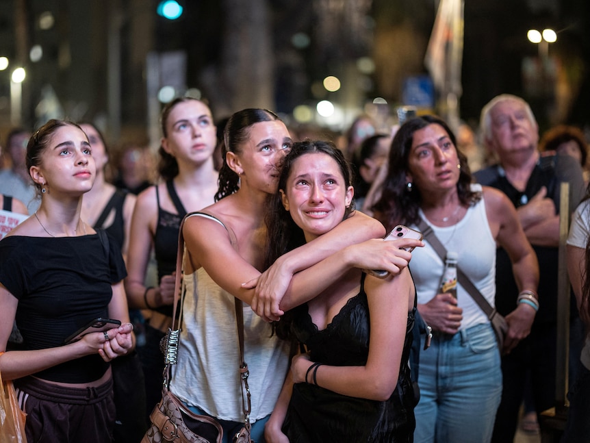 A crowd of young women looking worried and sad 