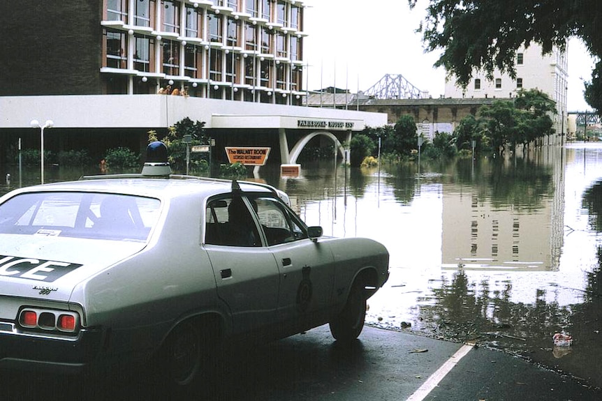 police car parked in front of flood waters in Brisbane 1974 