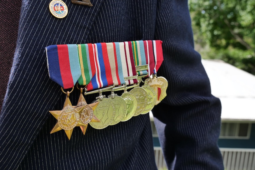 Jack Bartlett dons his War medals out the front of his Central Coast home.  