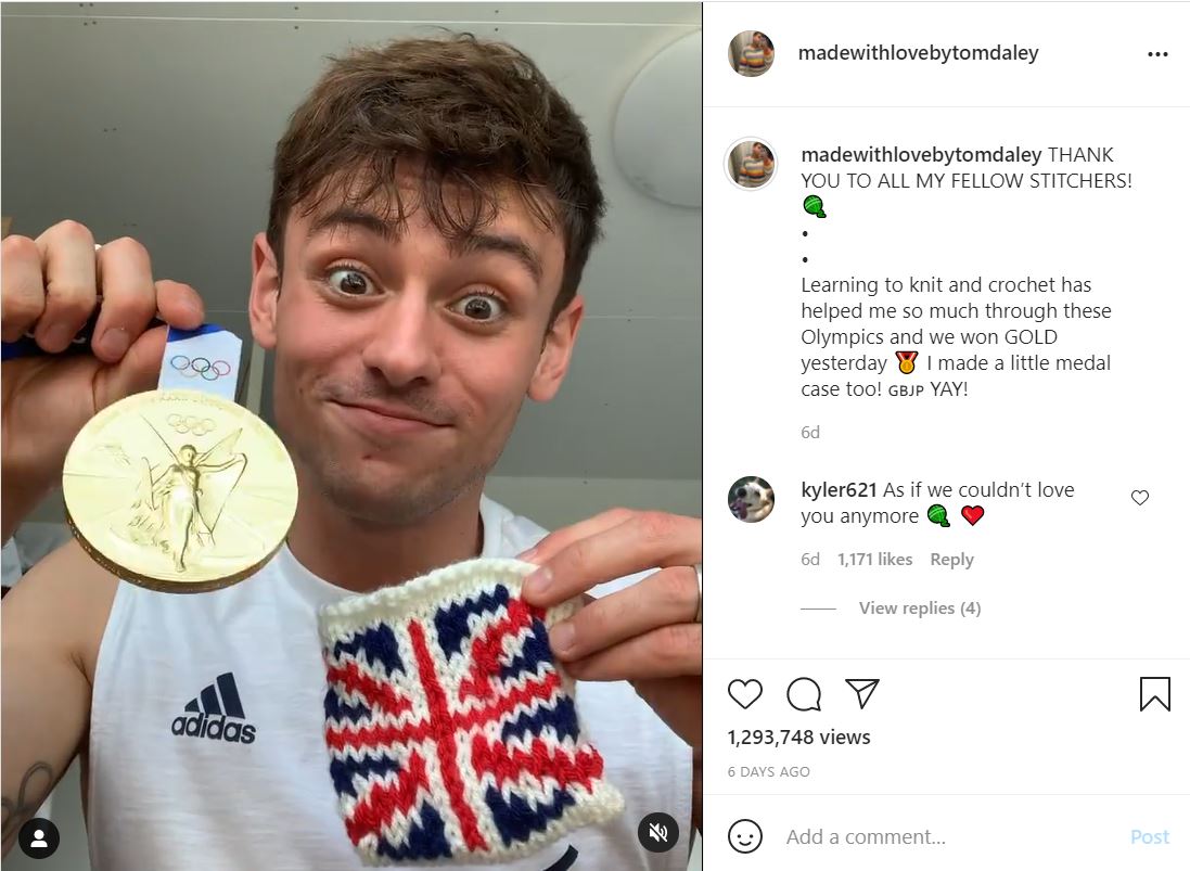 Tom Daley holds up a knitted cosy and his gold medal.