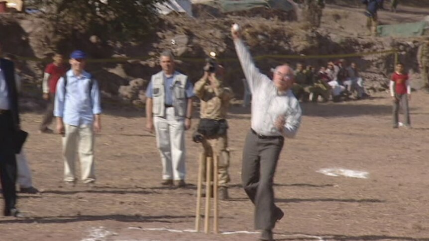 John Howard tries his hand at bowling during a 2005 prime ministerial visit to Pakistan.