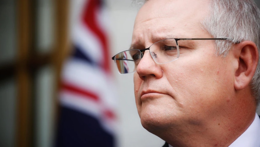 A close-up of Scott Morrison's face as he does a side glance
