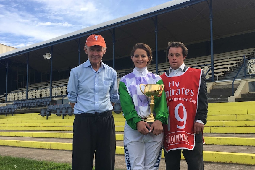 Paddy, Michelle and Stevie Payne standing with the Melbourne Cup in Ballarat
