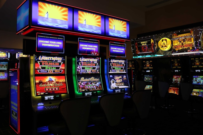 Several poker machines inside a club.