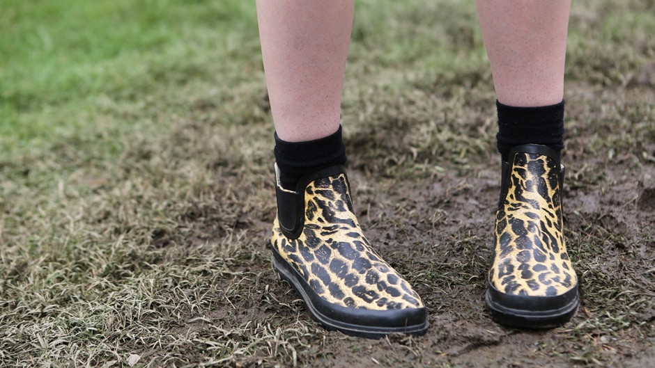 Leopard print gumboots in the mud.
