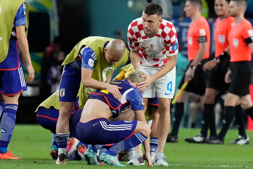 Croatia's Ivan Perisic comforts Japan's Takuma Asano after the penalty shootout at the Qatar FIFA World Cup.