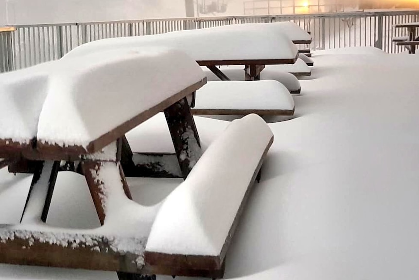 Heavy snow covering picnic tables at Mount Hotham.