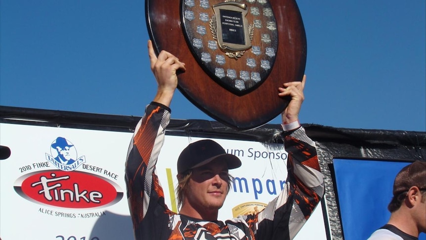 King of the Desert...Toby Price hoists the winner's shield.