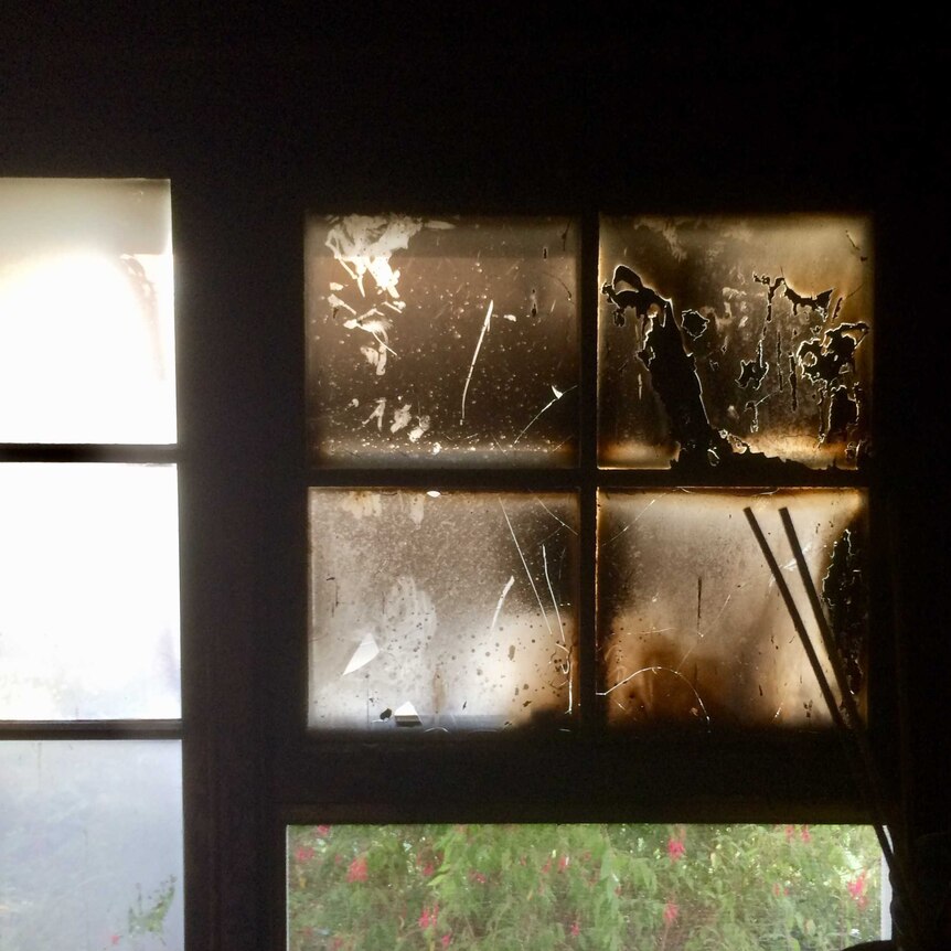 A glass window is blackened and nearly opaque.