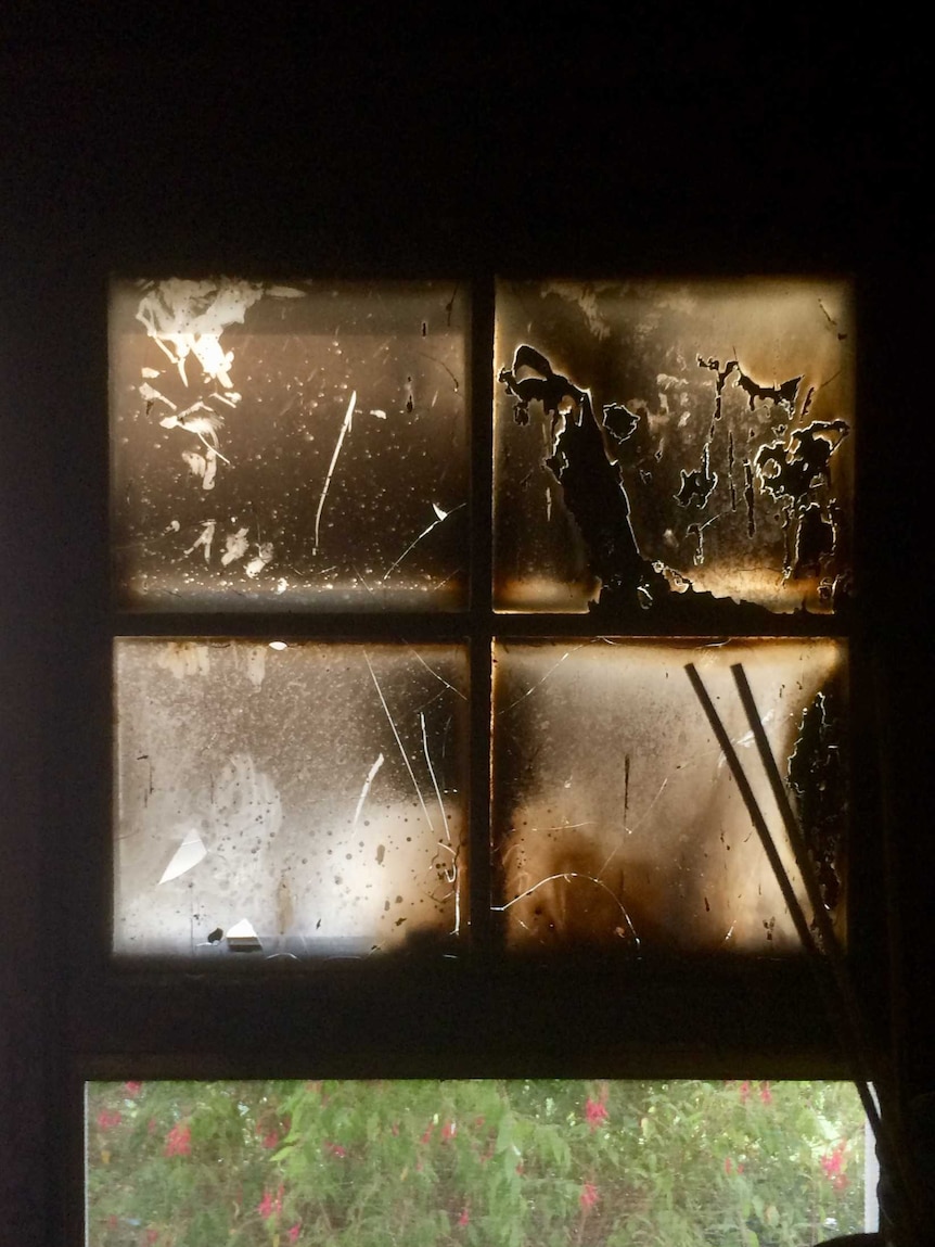 A glass window is blackened and nearly opaque.