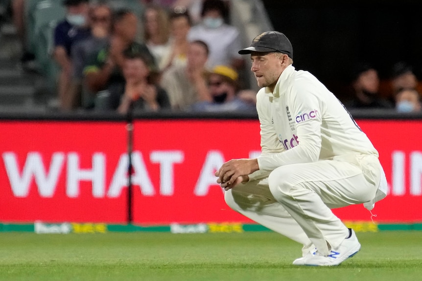 An English male cricketer crouches during second Ashes Test in Adelaide.