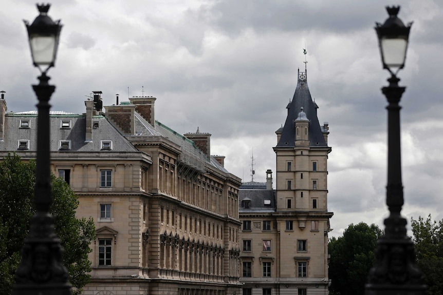 An old French-style building with stone walls and a dark tiled roof.