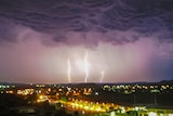 a lightning storm over an outback city