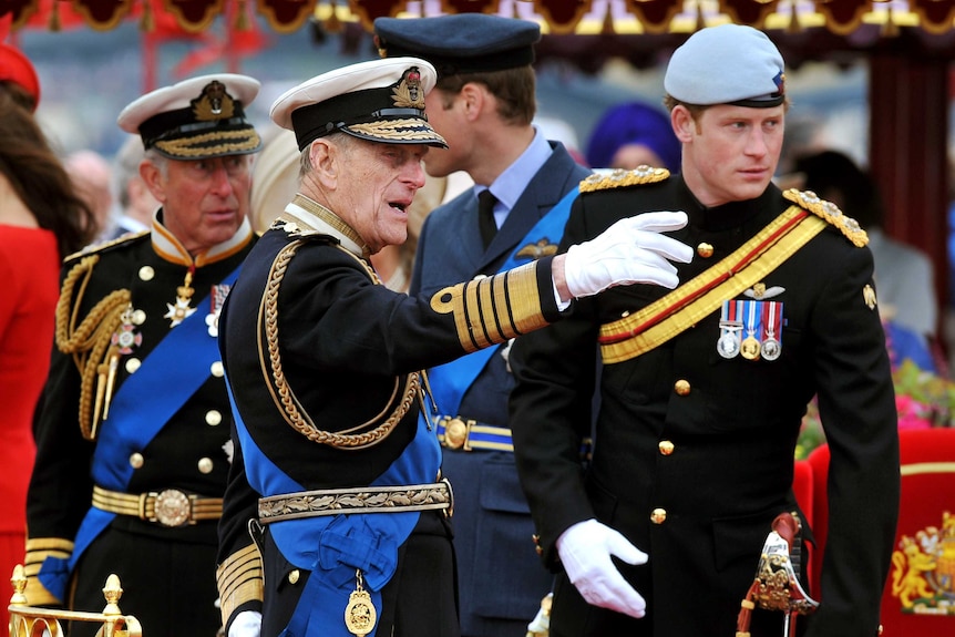 Prince Philip (C) talks to Prince Charles (L), Prince William (2nd R) and Prince Harry during a Diamond Jubilee event.