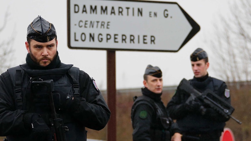 French gendarmes secure the roundabout near the scene of a hostage taking at an industrial zone in Dammartin-en-Goel