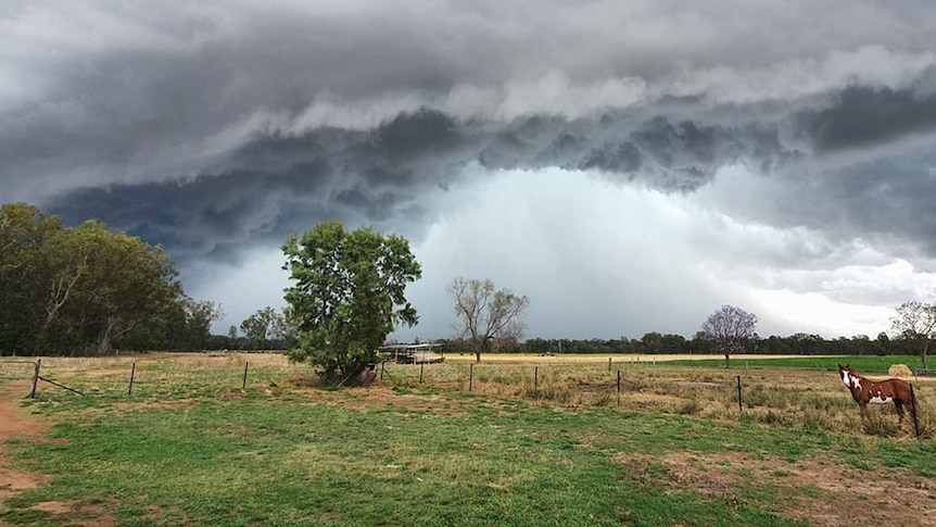 Storm clouds building over a rural property