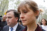 Allison Mack exits with her lawyer following a hearing on charges of sex trafficking.