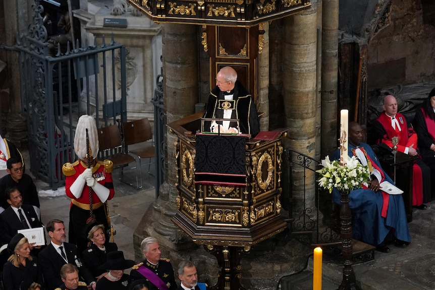 Archbishop of Canterbury Justin Welby stands above the crowd gathered at Westminster Abbey for the Queen's funeral. 