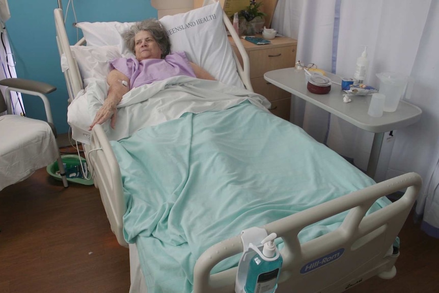 Elderly patient Alice Mather lies in a hospital bed at Caboolture Hospital, north of Brisbane.