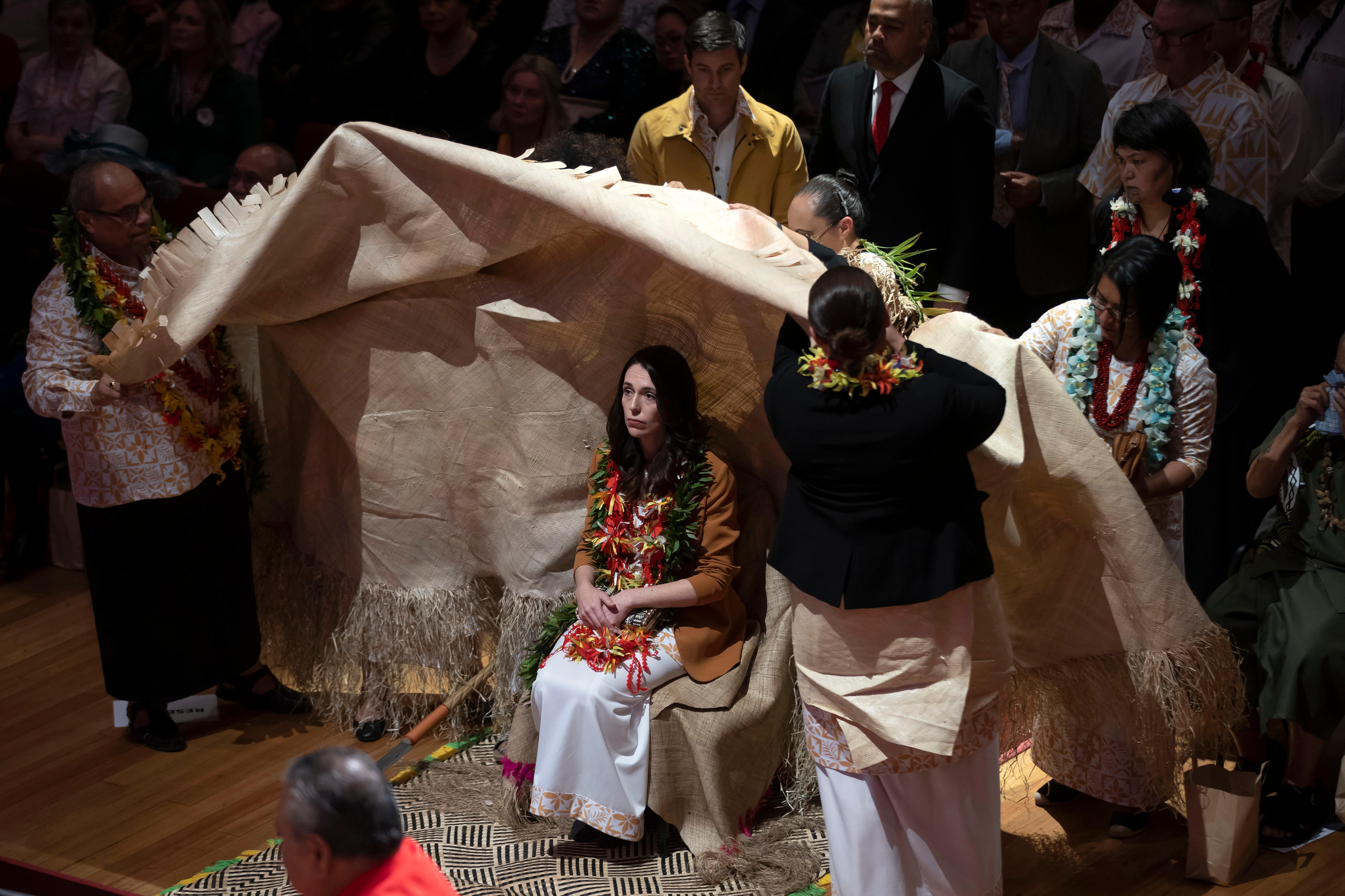 New Zealand Prime Minister Jacinda Ardern is covered during a ceremony in Auckland
