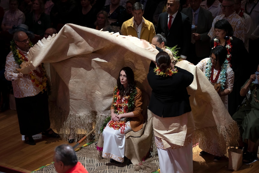 New Zealand Prime Minister Jacinda Ardern is covered during a ceremony in Auckland