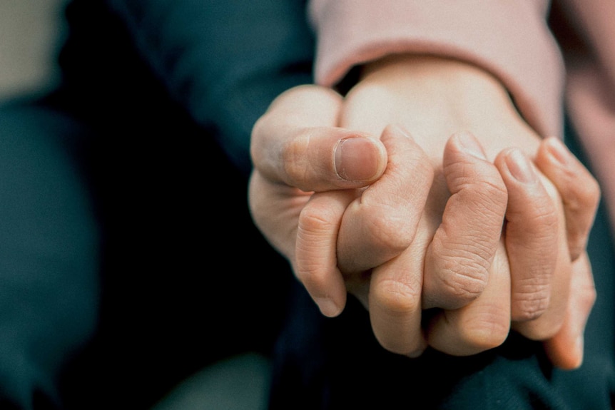 Close up of couple holding hands