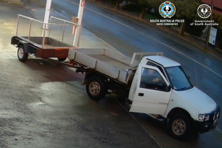 CCTV footage of a white utility towing a caged trailer