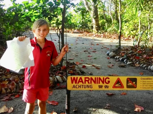 Boy holds up letter to Queensland Environment Minister Leanne Enoch