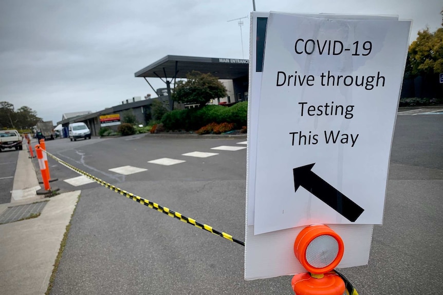 A laminated sign shows drivers where to go for drive through coronavirus testing.
