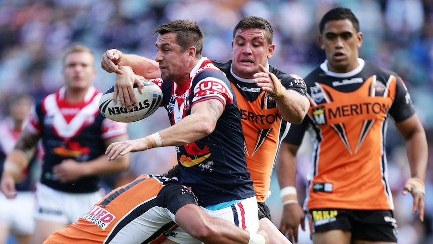 Attacking display ... Mitchell Pearce looks to keep the ball alive with an off-load