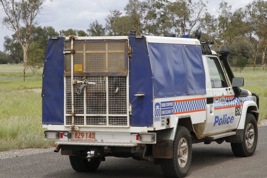 An Australian Police van drives away with Jermaine Austral in the rear cage