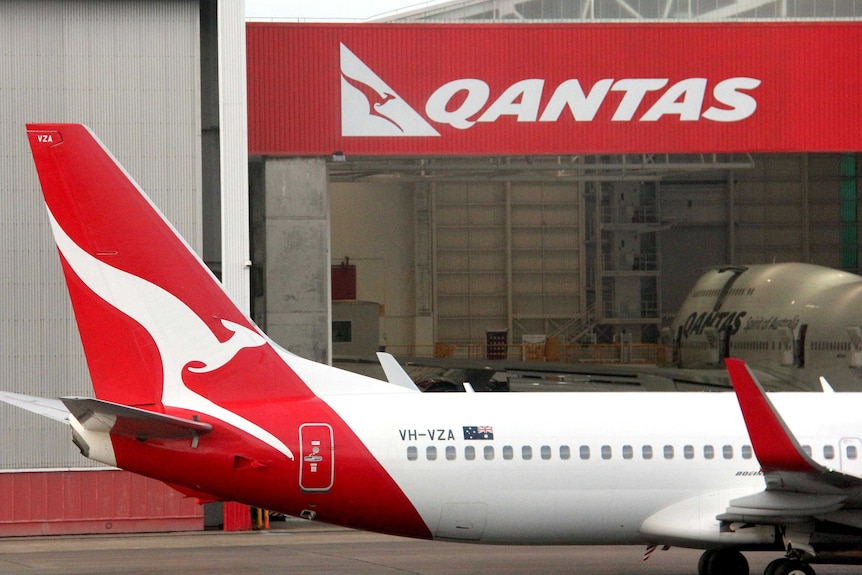 Qantas jet taxis through Sydney Airport.