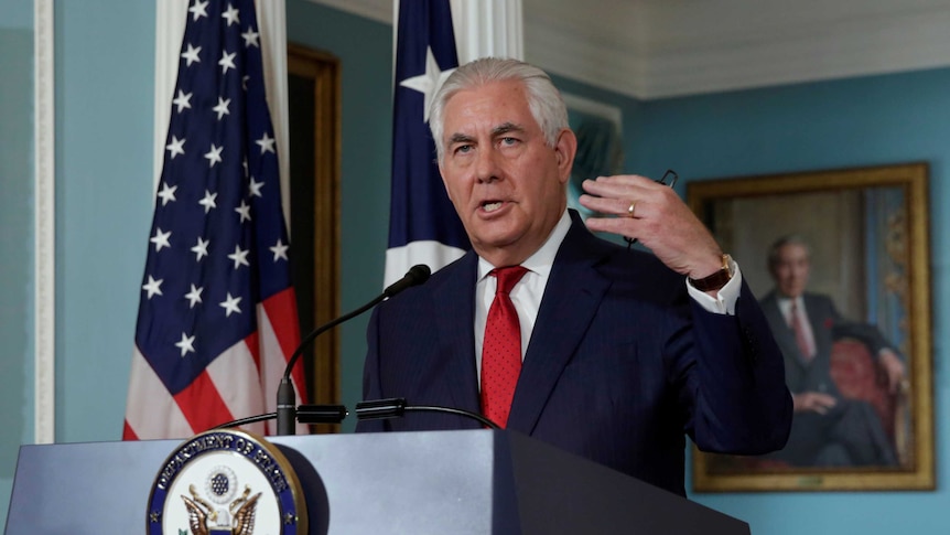Tillerson gestures with his right hand as he makes a statement from the State Department in Washington