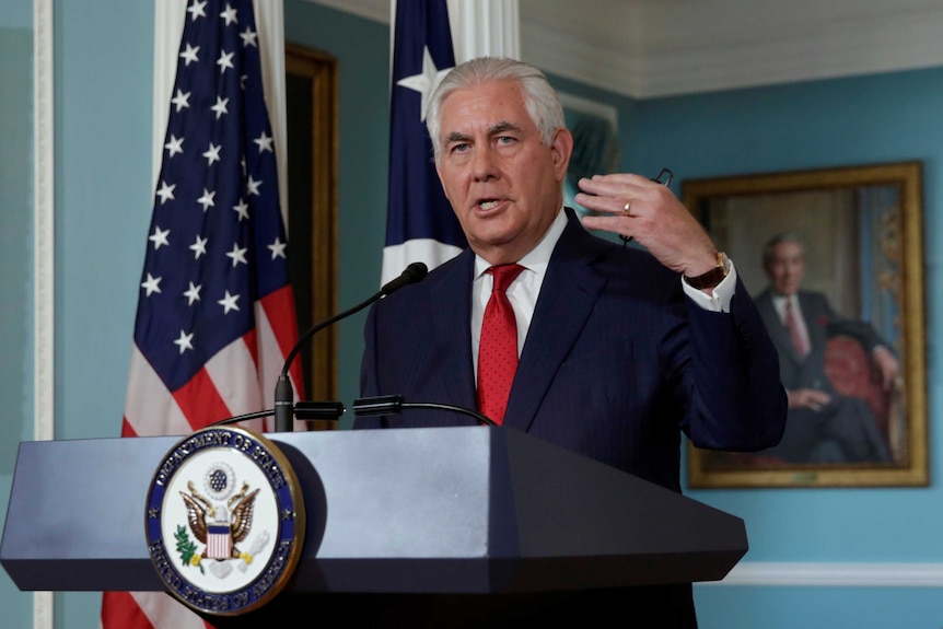 Tillerson gestures with his right hand as he makes a statement from the State Department in Washington