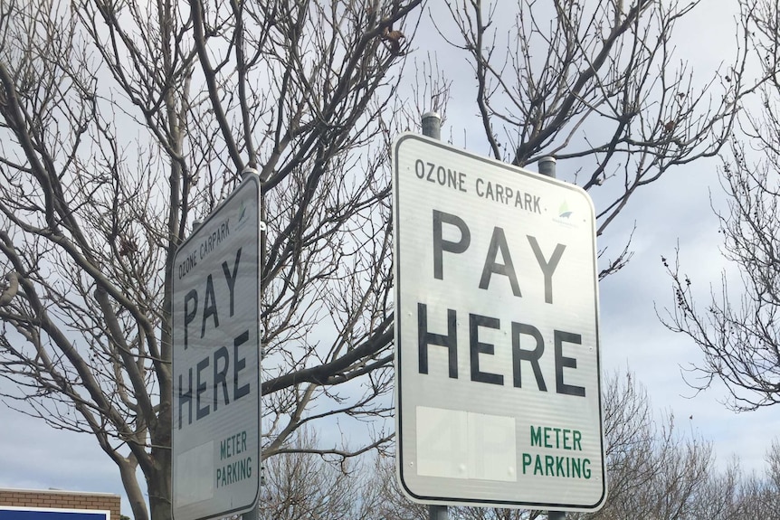 Signs in a carpark indicating where people have to pay.