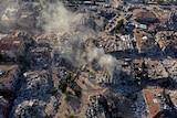 Destroyed buildings and dust seen rising from aerial view of city of Antakya, Turkiye.