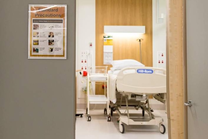 A hospital bed is seen from a corridor at a Melbourne hospital.