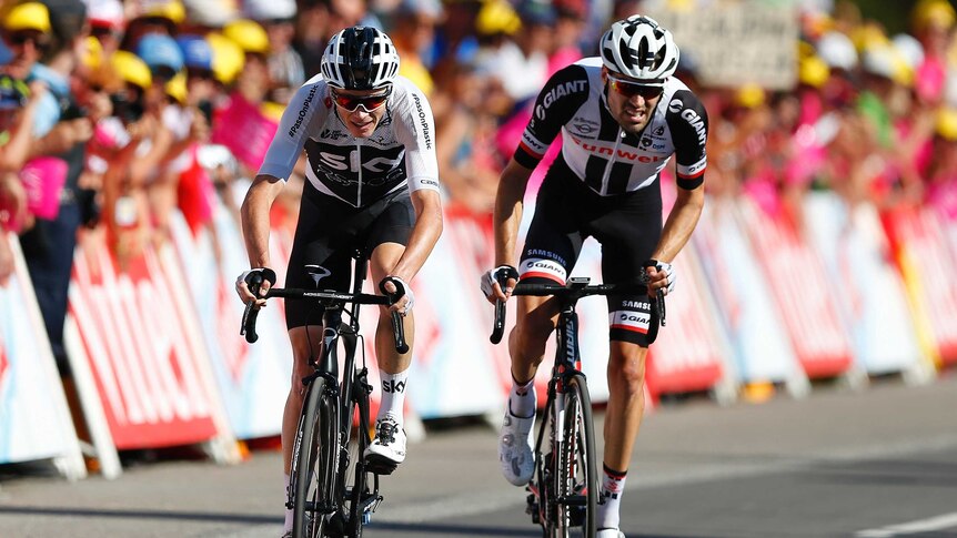 Chris Froome and Tom Dumoulin stand on the pedals to get up over the final hill on stage 11.