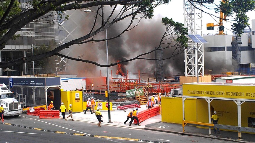 Workers rush into action after a fire started at the Barangaroo construction site in the Sydney CBD.