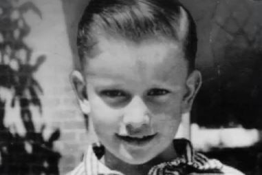 A black and white image of a young boy who was murdered after his parents won a lottery in 1960.