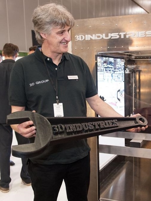 Melbourne-based inventor Jason Simpson holds a large 3D-printed spanner.