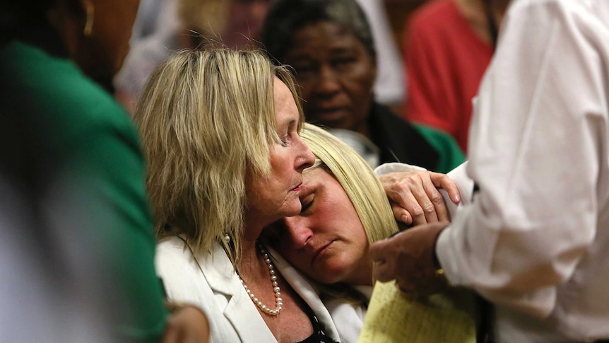 June Steenkamp (L), mother of Reeva Steenkamp, comforts Reeva's cousin Kim Martin during the verdict in the trial of Oscar Pistorius.