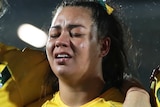 Jillaroos Holli Wheeler, Kennedy Cherrington and Taliah Fuimaono stand arm in arm to sing the national anthem.