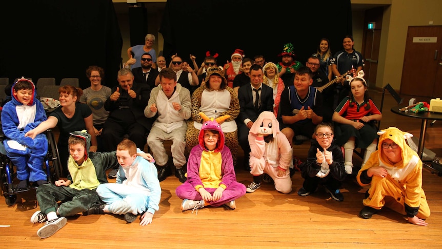 A large group of people cheering at the camera. A group shot of the entire cast of 'Follow that Cat' and 'Knock and Run'.