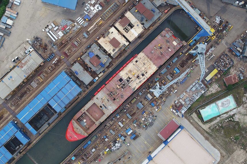An aerial view of a ship being built at a shipyard